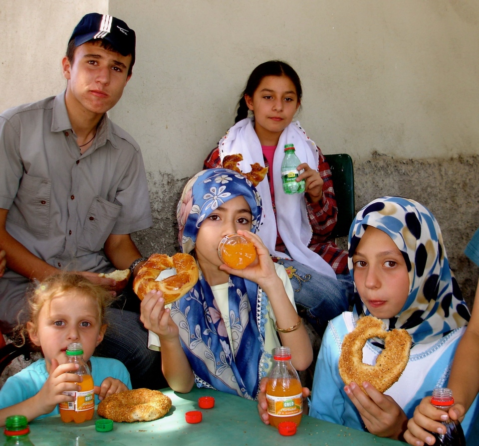 The qur'anic class concludes with refreshments, Arapgir, Turkey. Note the difference in headwear 